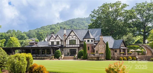 a front view of a house with a yard table and chairs