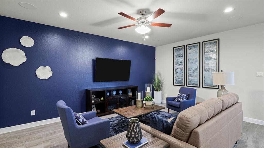 15540 Balham Path Fort Worth, TX 76247 - Photo 11 of 40 a living room with furniture a fireplace and a flat screen tv