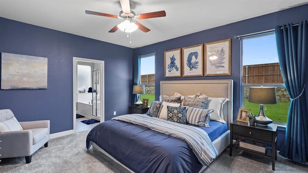 15540 Balham Path Fort Worth, TX 76247 - Photo 14 of 40 a bedroom with a bed and a chandelier