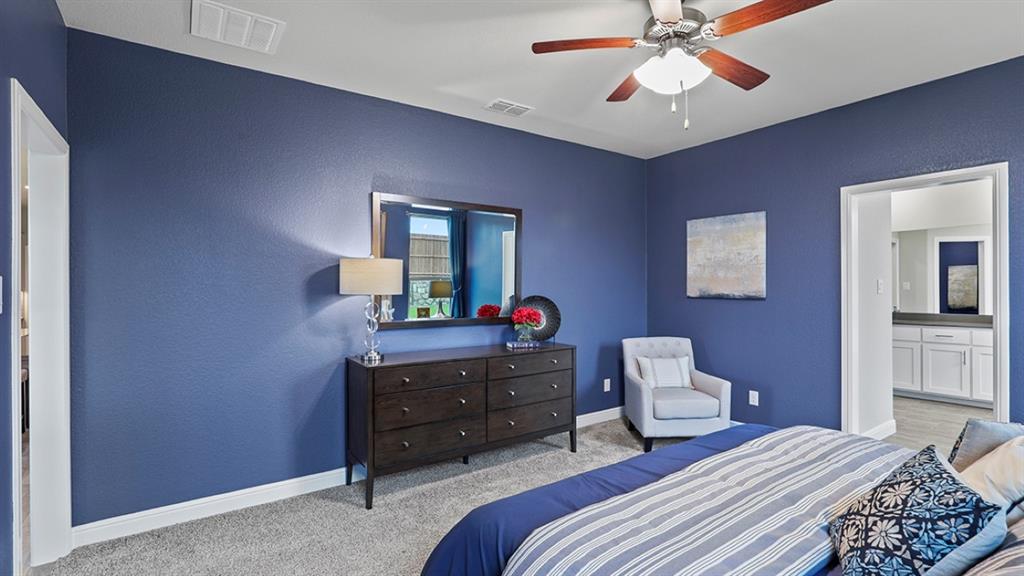 15540 Balham Path Fort Worth, TX 76247 - Photo 15 of 40 a bedroom with a bed and a mirror on the dresser
