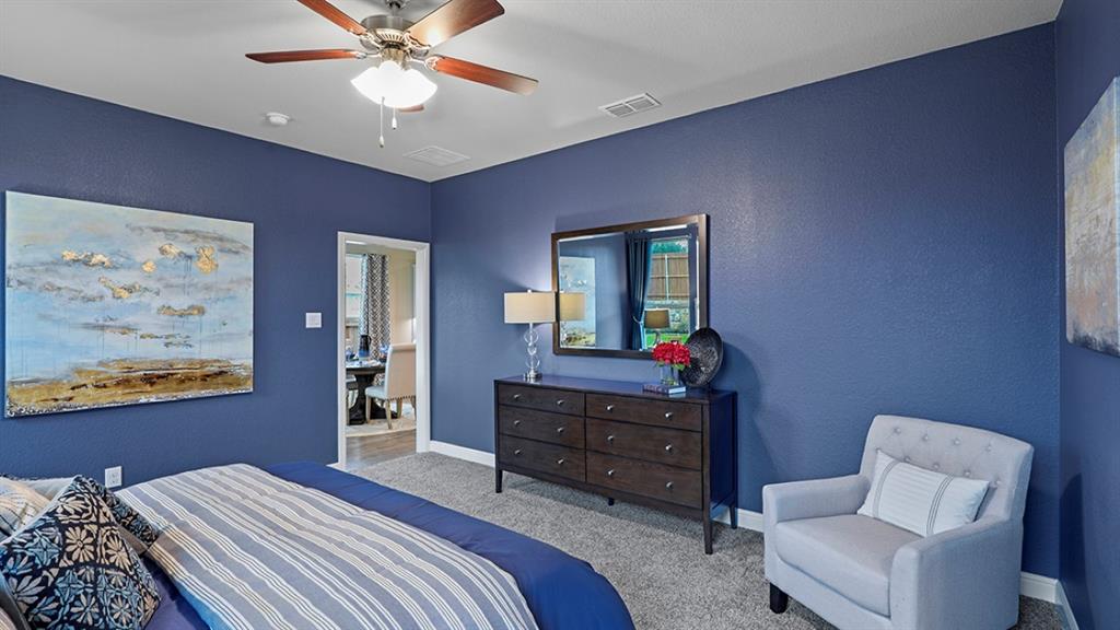 15540 Balham Path Fort Worth, TX 76247 - Photo 16 of 40 a bedroom with a bed and a chandelier