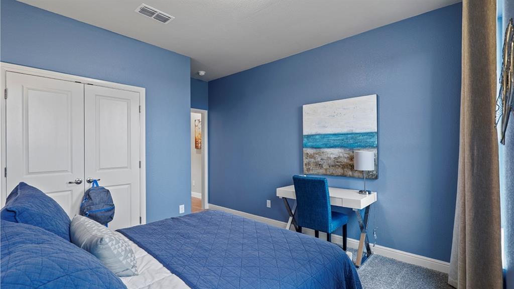 15540 Balham Path Fort Worth, TX 76247 - Photo 19 of 40 a bedroom with a bed and a table in it