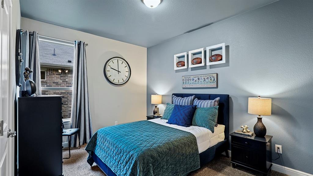 15540 Balham Path Fort Worth, TX 76247 - Photo 23 of 40 a bedroom with a bed and a lamp on dresser