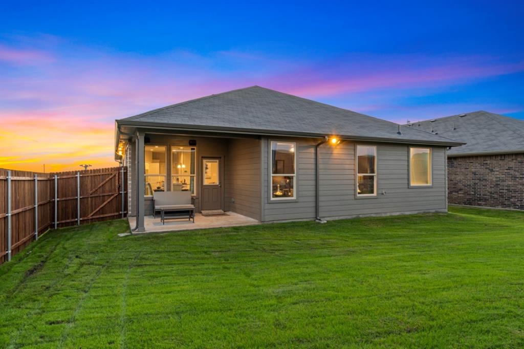 15540 Balham Path Fort Worth, TX 76247 - Photo 39 of 40 a backyard of a house with table and chairs