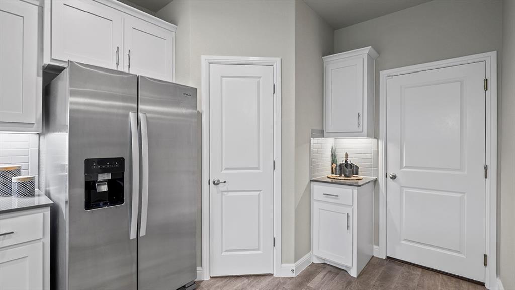 15540 Balham Path Fort Worth, TX 76247 - Photo 5 of 40 a kitchen with cabinets and stainless steel appliances