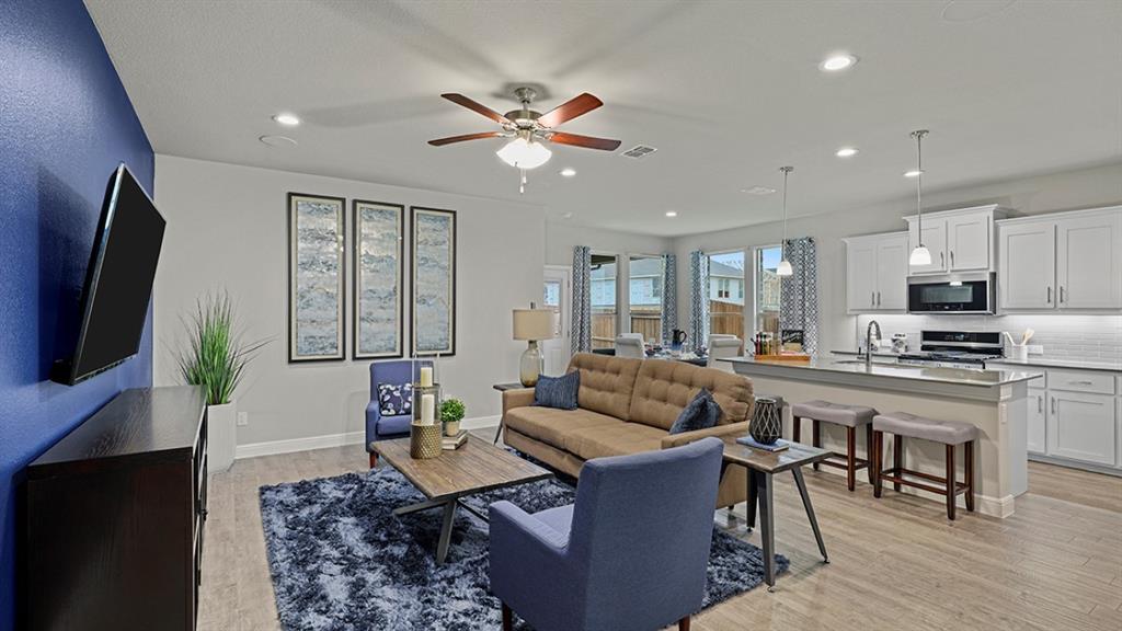 15540 Balham Path Fort Worth, TX 76247 - Photo 6 of 40 a living room with fireplace furniture and a flat screen tv