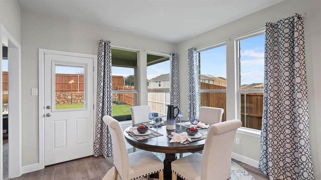 15540 Balham Path Fort Worth, TX 76247 - Photo 7 of 40 a view of a dining room with furniture window and wooden floor