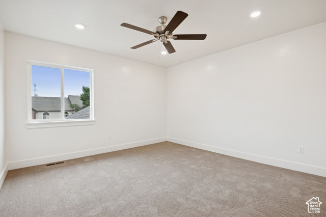 1615 North Angel Street, Unit F Layton, UT 84041 - Photo 13 of 45 Spare room with light colored carpet, recessed lighting, and ceiling fan