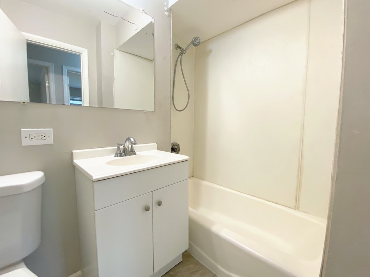 23922 South Cretewood Lane Crete, IL 60417 - Photo 11 of 18 a bathroom with a sink and a mirror