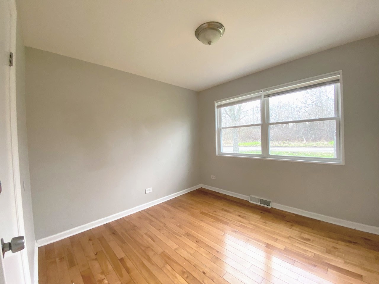 23922 South Cretewood Lane Crete, IL 60417 - Photo 12 of 18 a view of an empty room with wooden floor and a window
