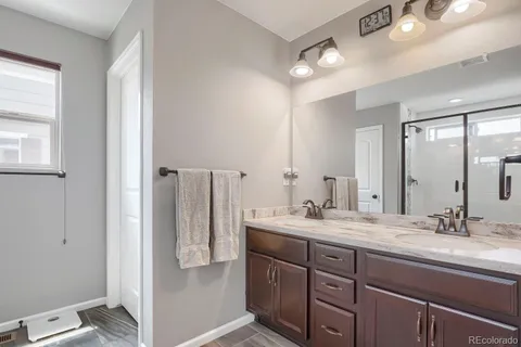 a bathroom with a double vanity sink and mirror