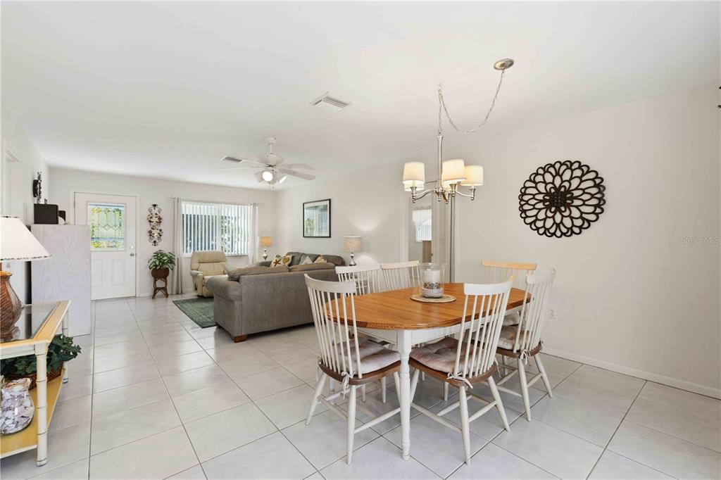 840 Channel Acres Road Nokomis, FL 34275 - Photo 14 of 48 a dining room with furniture and a chandelier