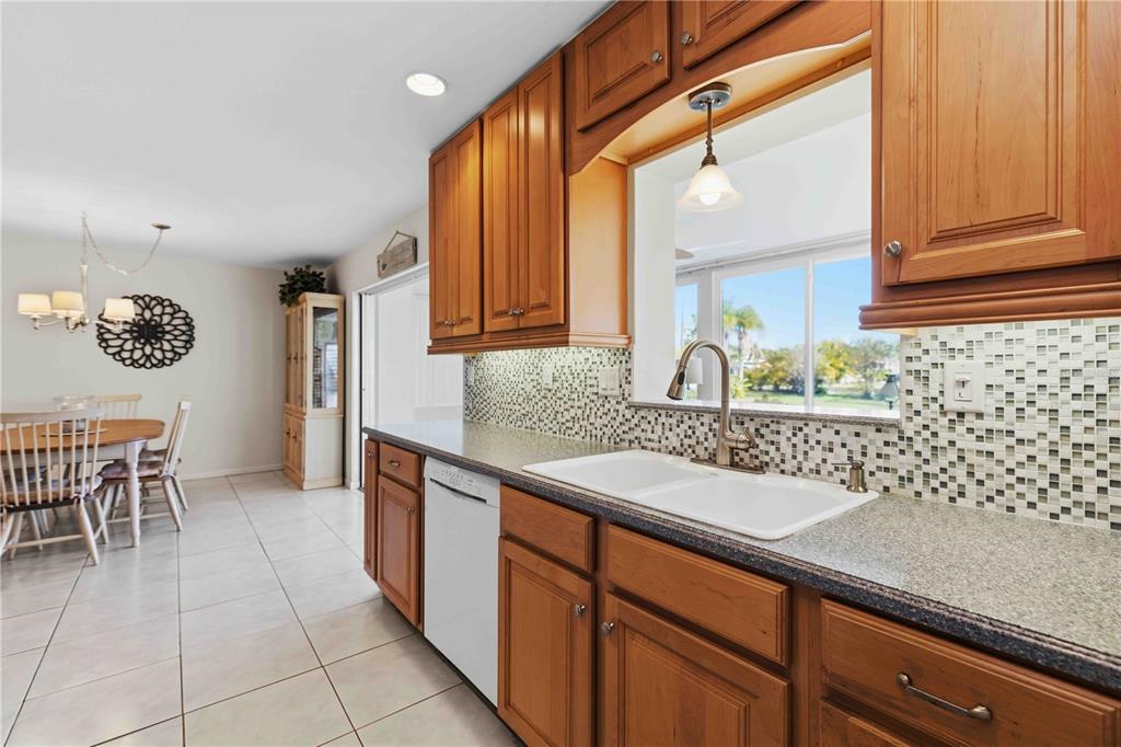 840 Channel Acres Road Nokomis, FL 34275 - Photo 18 of 48 a kitchen with stainless steel appliances granite countertop a sink and a cabinets