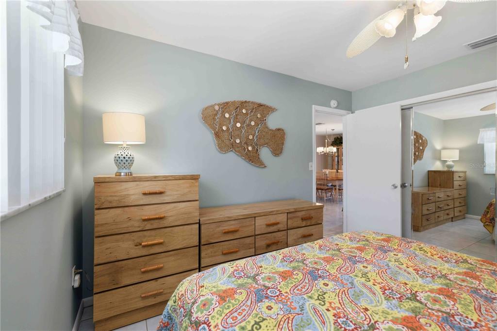 840 Channel Acres Road Nokomis, FL 34275 - Photo 26 of 48 a bedroom with a bed and a dresser