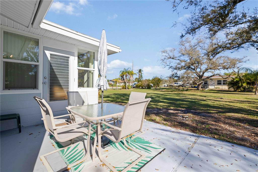 840 Channel Acres Road Nokomis, FL 34275 - Photo 33 of 48 a view of a patio with a table chairs and a patio