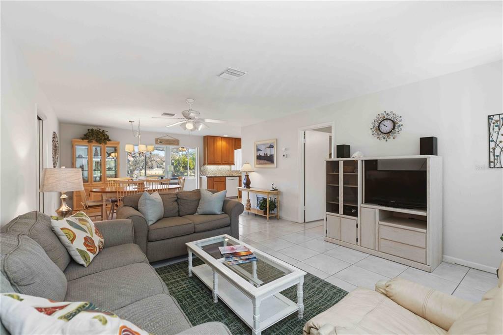 840 Channel Acres Road Nokomis, FL 34275 - Photo 8 of 48 a living room with furniture and a flat screen tv