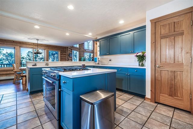 a kitchen with a sink a counter top space and appliances