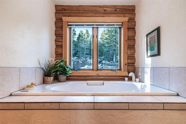 a bath tub sitting next to a window