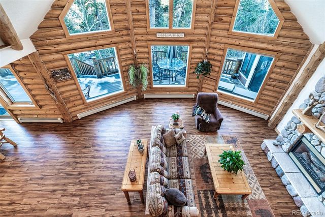 a view of a patio with couches chairs and wooden floor