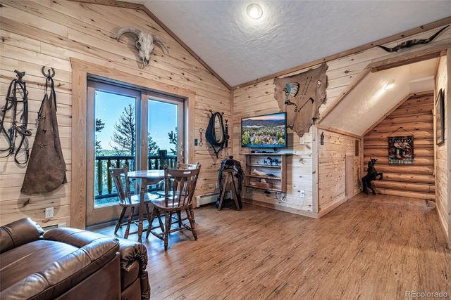 a view of a livingroom with furniture wooden floor and windows