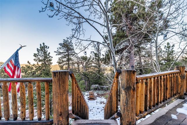 a view of a patio with table and chairs with wooden floor and fence