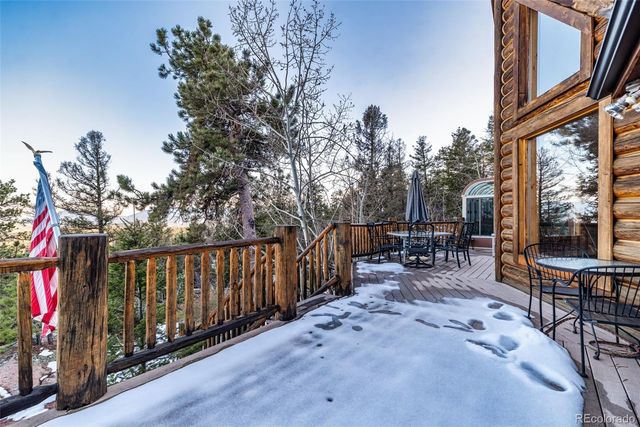 a view of a chairs and table in the backyard