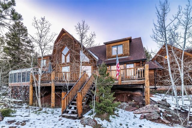 a view of a house with a wooden deck