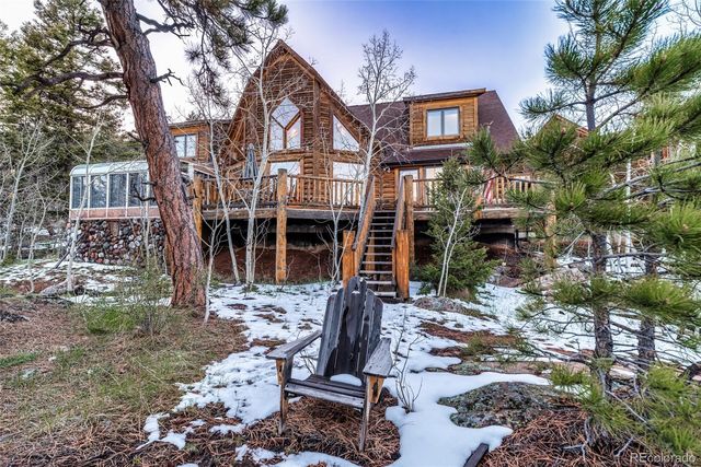 a view of a brick house with many windows next to a yard