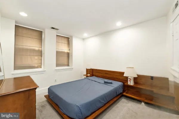 a bedroom with a bed and a cabinets