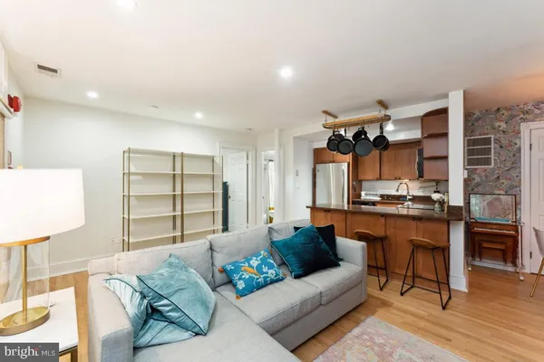 a kitchen with stainless steel appliances granite countertop a refrigerator a stove top oven a sink and dishwasher