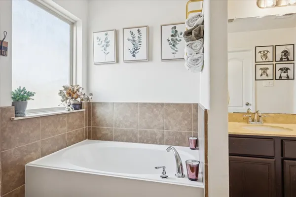 a bathroom with a bathtub and sink