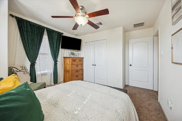 a bedroom with a bed closet and a window