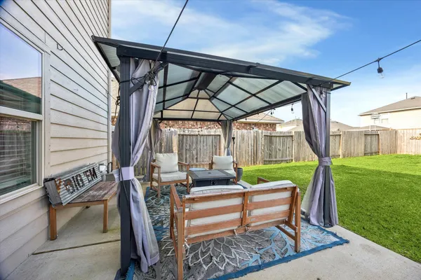 a sitting area with furniture and wooden deck