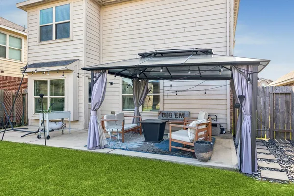 a front view of a house with a garden and patio