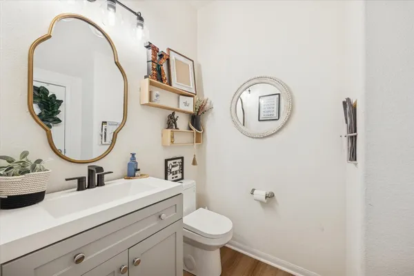 a bathroom with a toilet a sink and a mirror