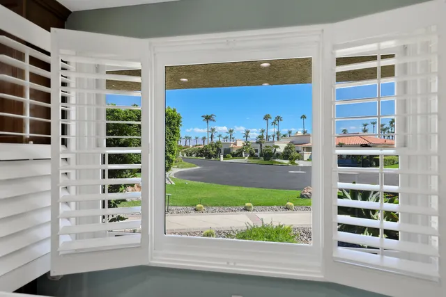 a view of a house with swimming pool and a porch