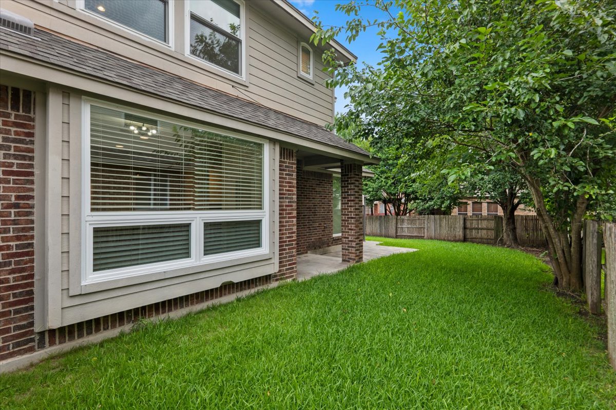2304 Village View Loop Pflugerville, TX 78660 - Photo 6 of 40 A well-kept yard offers a green oasis adjacent to the brick and siding exterior of this inviting home.