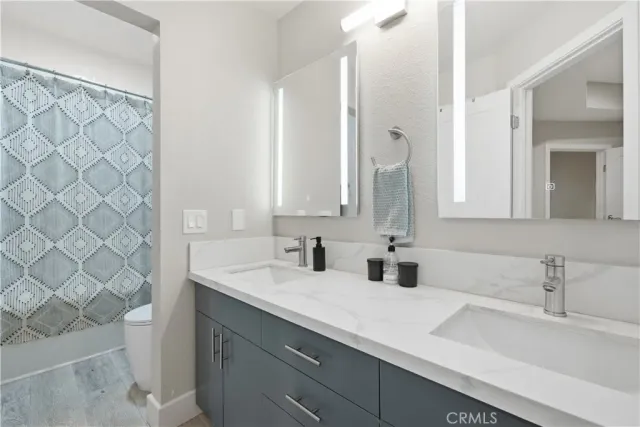 a bathroom with a double vanity sink mirror and double