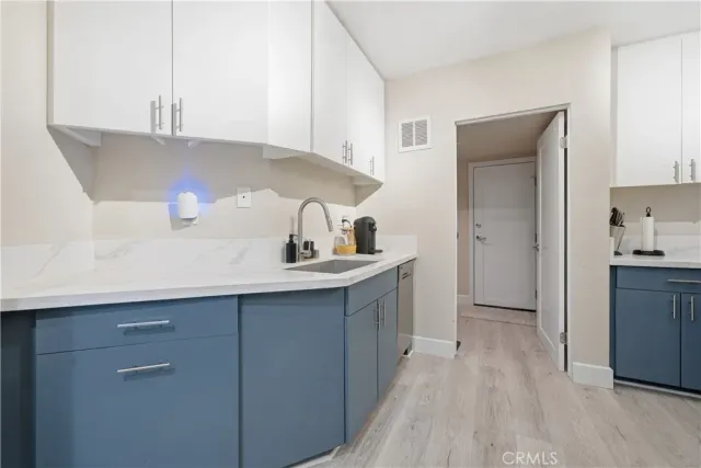 a kitchen with a sink and a refrigerator