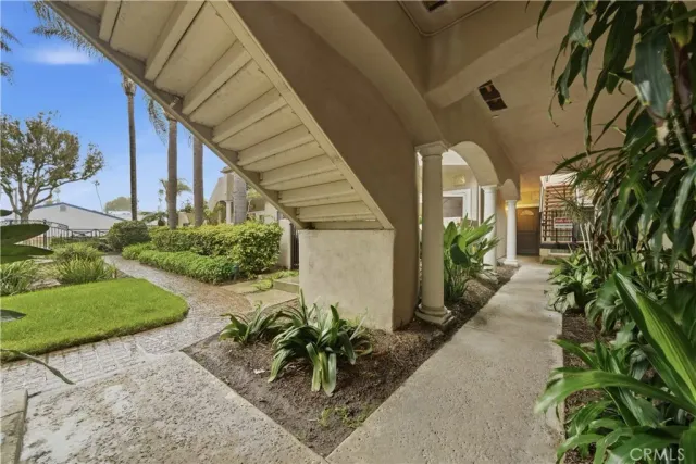 a house with potted plants in front of it