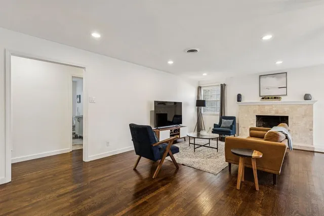 a living room with furniture a fireplace and a flat screen tv