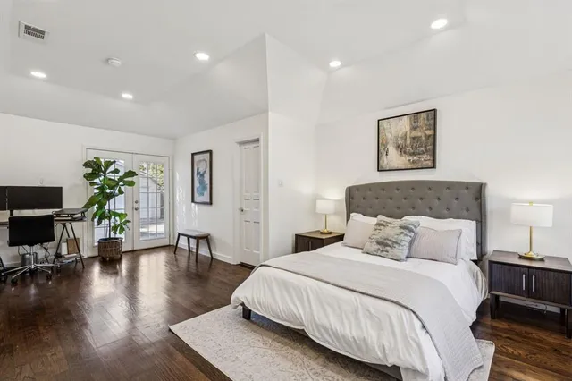 a spacious bedroom with a bed and a couch