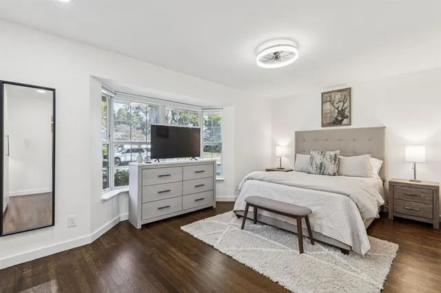 a bedroom with a bed and a flat screen tv