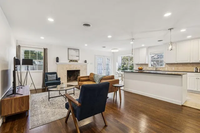 a living room with fireplace furniture and a wooden floor