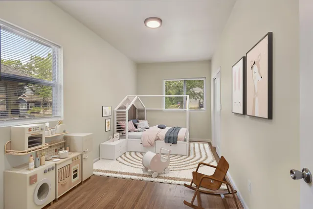 a living room with furniture a fireplace and windows