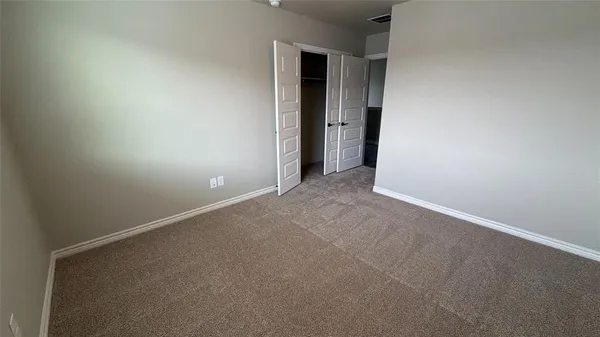 a hallway with granite countertop white cabinets and sink