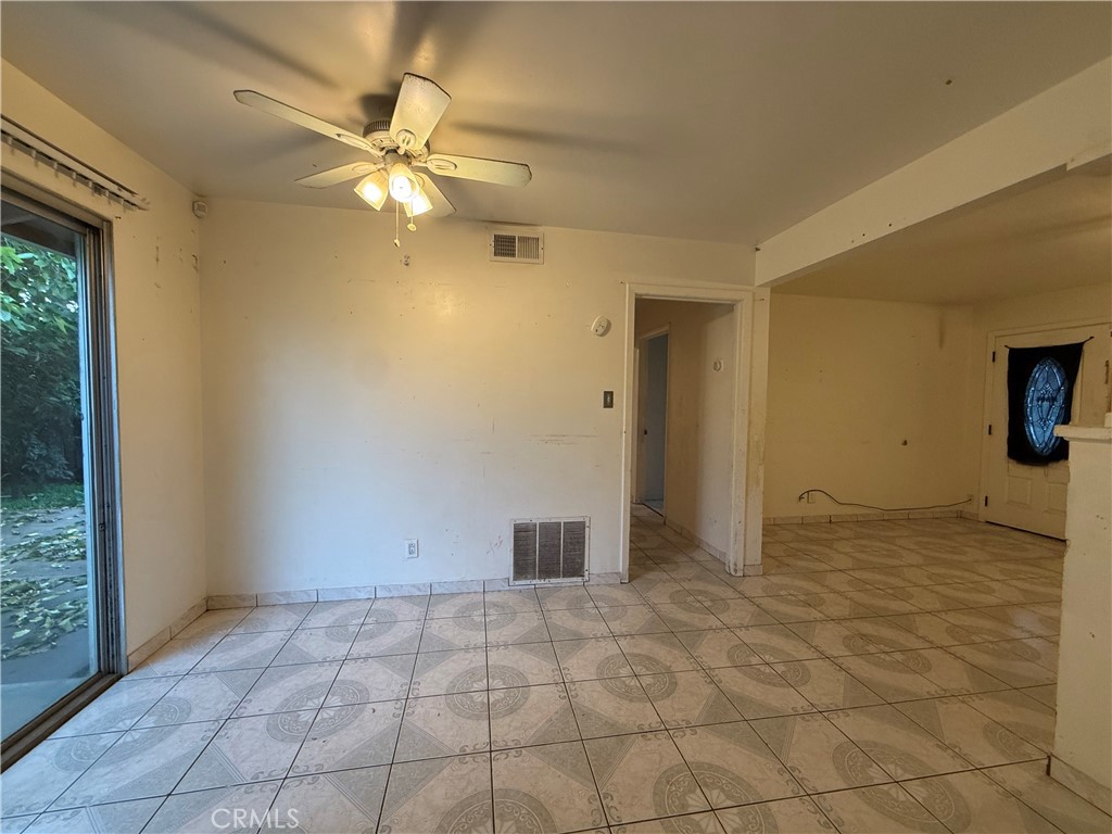 1616 East 21st Street Merced, CA 95340 - Photo 3 of 22 a view of an empty room with window and chandelier fan