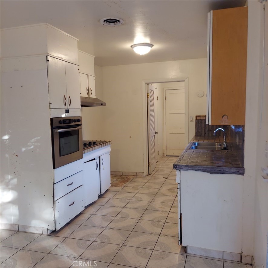 1616 East 21st Street Merced, CA 95340 - Photo 7 of 22 a kitchen with stainless steel appliances granite countertop a sink and cabinets