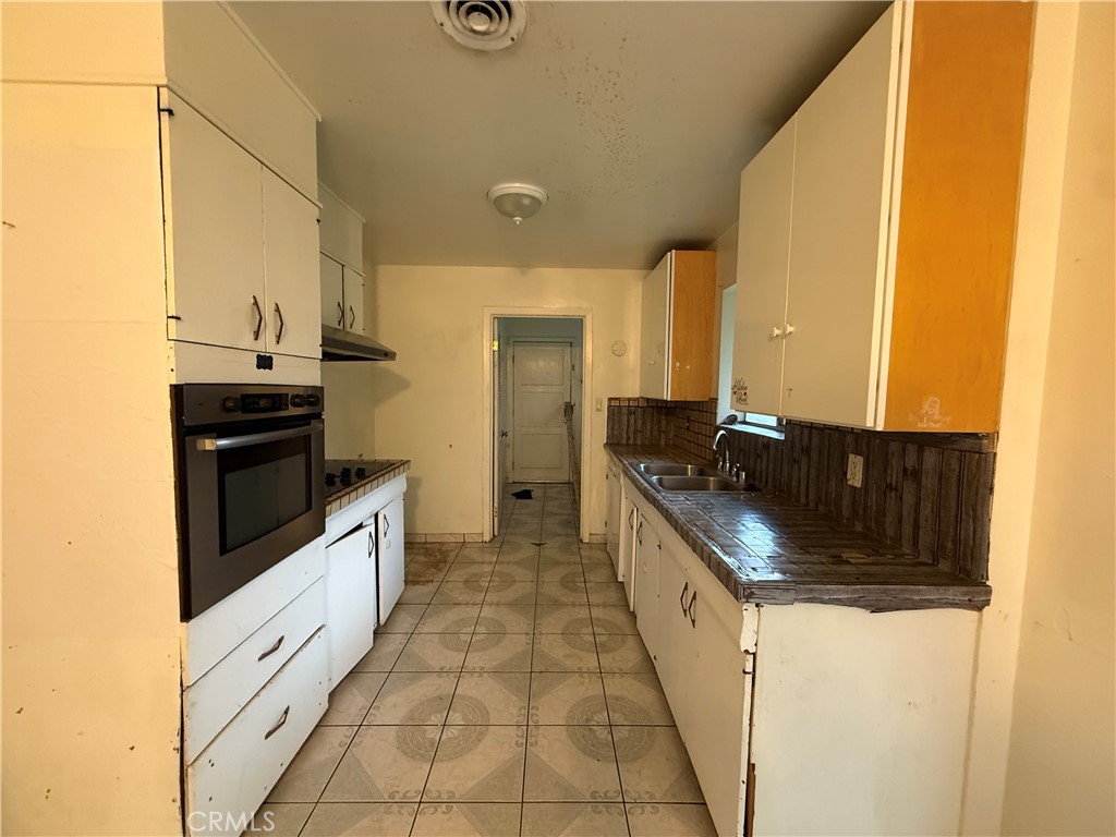 1616 East 21st Street Merced, CA 95340 - Photo 8 of 22 a kitchen with granite countertop a sink and a stove top oven