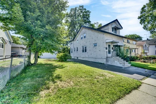 a view of a house with backyard and a garden
